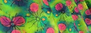 Vibrant green, pink yellow and blue biology inspired design printed on fabric.