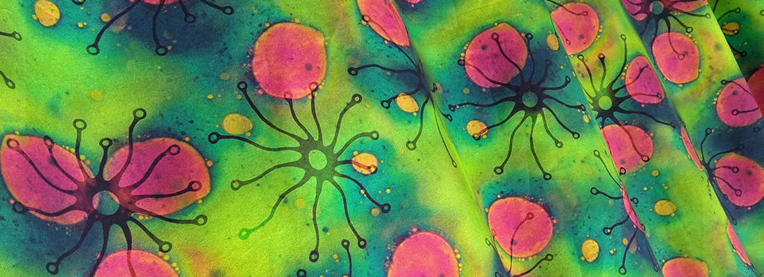 Vibrant green, pink yellow and blue biology inspired design printed on fabric.