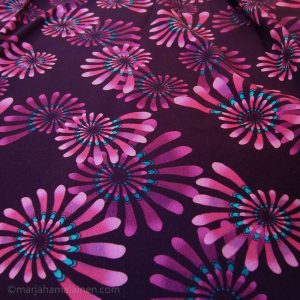 Psychedelic pink spirals print on fabric.